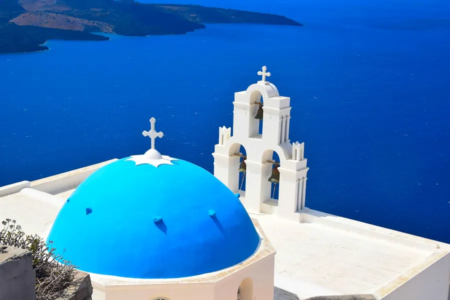 Blue-domed churches of Santorini at sunset