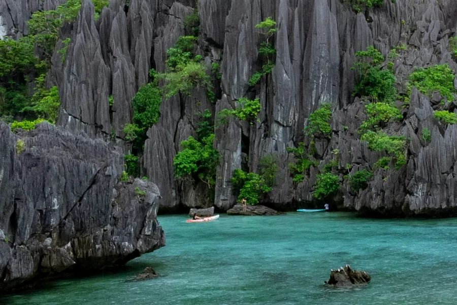 Turquoise lagoon surrounded by limestone karst islands in El Nido