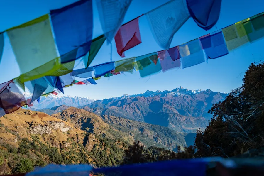 Snow-capped Himalayan peaks above prayer flags