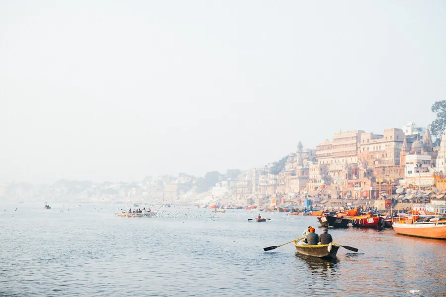 Sunrise boat ride on the Ganges with temples along the ghats