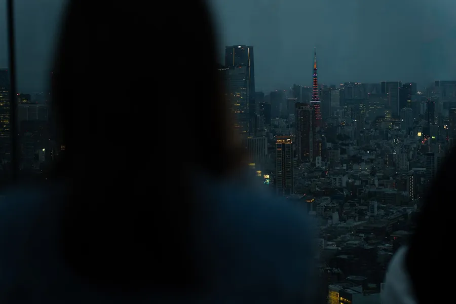 Neon-lit Tokyo street at night with crowds