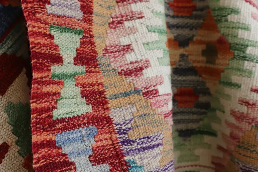 Colourful Ghanaian kente cloth being woven on a loom
