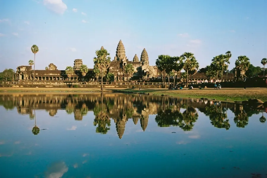 Angkor Wat temple reflected in water at sunrise